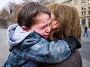 Chłopiec płacze obejmując mamę