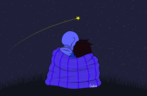 Mama i dziecko otuleni kocem patrzący na spadającą gwiazdę